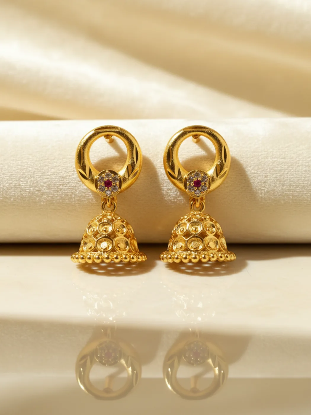 Gold-plated jhumka earrings with a hoop top and ruby stone